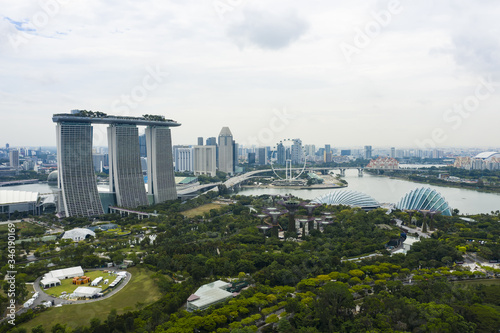 View from above, stunning aerial view of the skyline of Singapore during a cloudy day with the financial district in the distance.