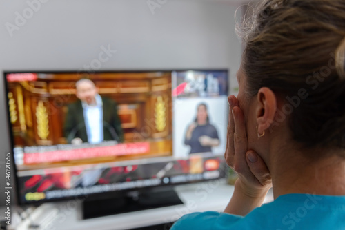 shocked woman looking the TV close up