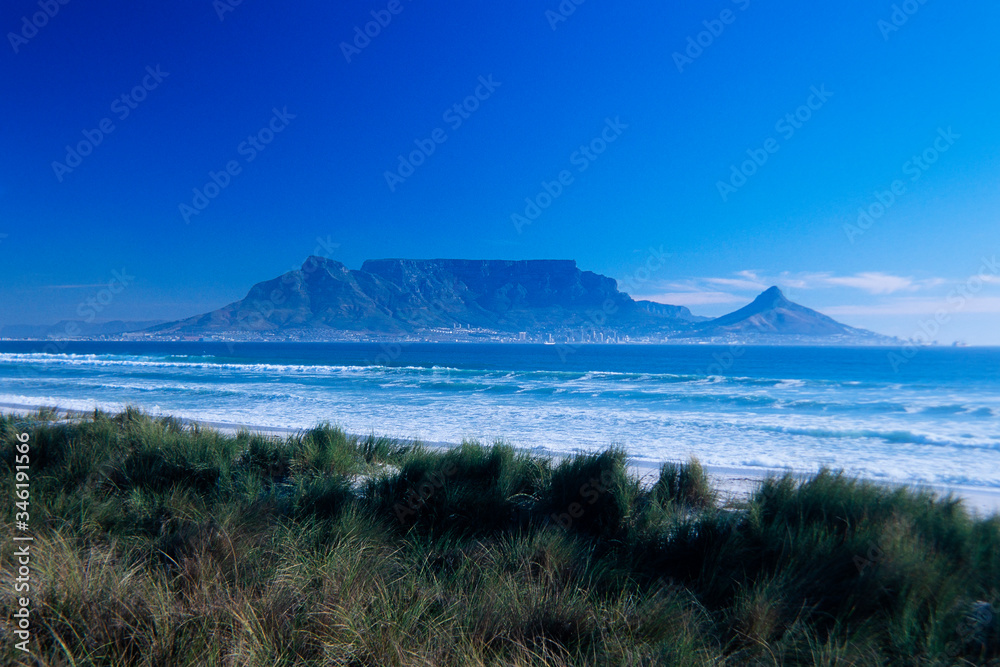Table Mountain and Cape Town seen from across Table Bay.
Bloubergstrand Beach in the forreground.