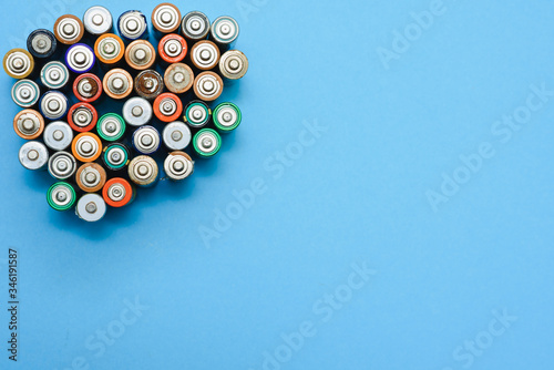 Many used batteries from different manufacturers. Old batteries for recycling.