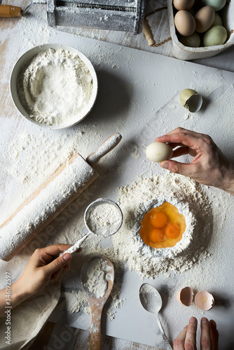 Overhead view of chef's hands making fettuccine pasta with heirloom eggs