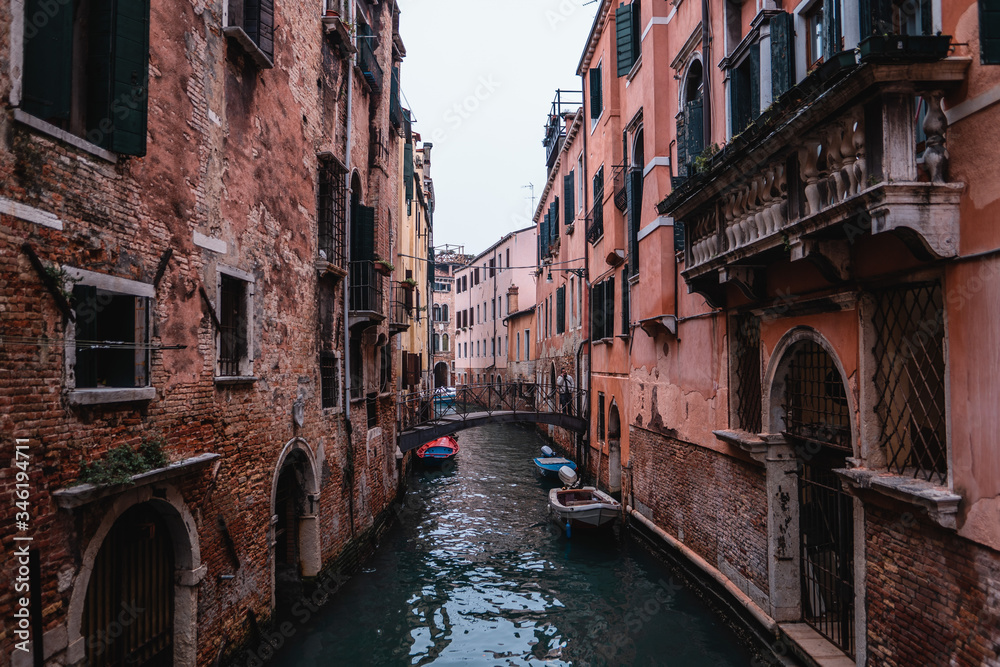 Travel to Venice with city panorama in Italy with small canal and old buildings