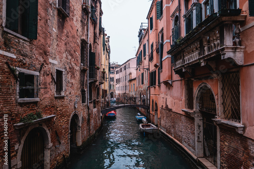 Travel to Venice with city panorama in Italy with small canal and old buildings