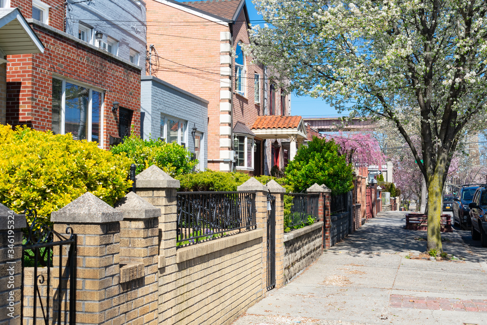 Beautiful Spring Sidewalk with Homes and Colorful Plants in Astoria Queens New York