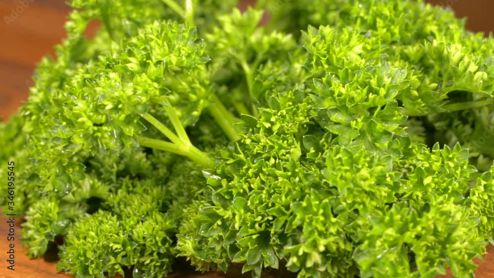 Green salad. Parsley on a cutting board close-up. Vegetarian food. Green salad. Parsley on a cutting board close-up. Vegetarian food.