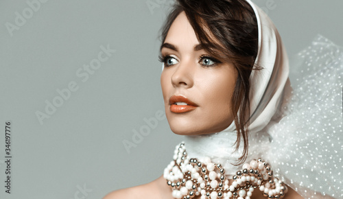 Photos Portrait of young sensual romantic brunette woman in white stylish hood, jewelry