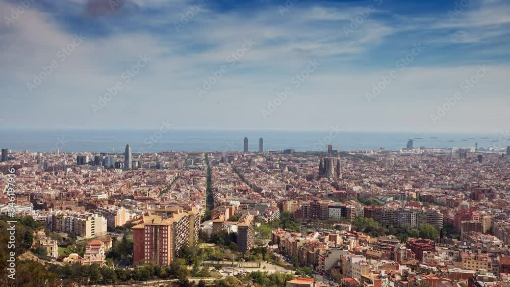 Timelapse scenery with the town near the sea and cloudy sky. Beautiful landscape view of town near the sea. Panoramic view on the area of town. Barcelona, Spain. Timelapse scenery with the town near the sea and cloudy sky. Beautiful landscape view of town near the sea. Panoramic view on the area of town. Barcelona, Spain.