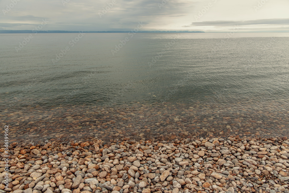Transparent water of Lake Baikal and stones on the shore and under water