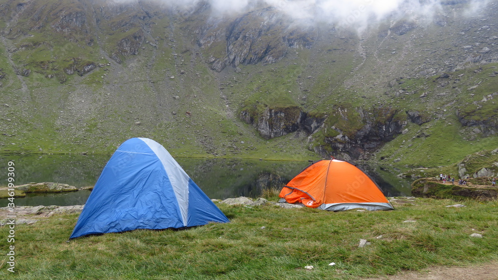 Camping at a Mountain Lake in a Misty Landscape

