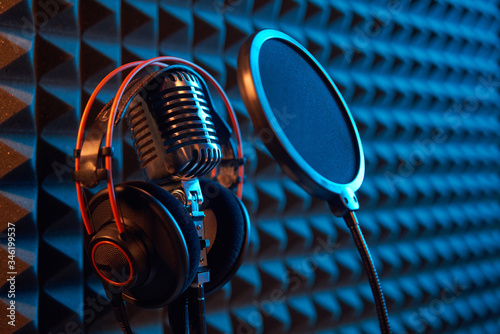 Studio condenser microphone with professional headphones acoustic panel photo