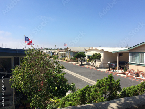 Trailer park mobile homes america flag with clean street sunny day