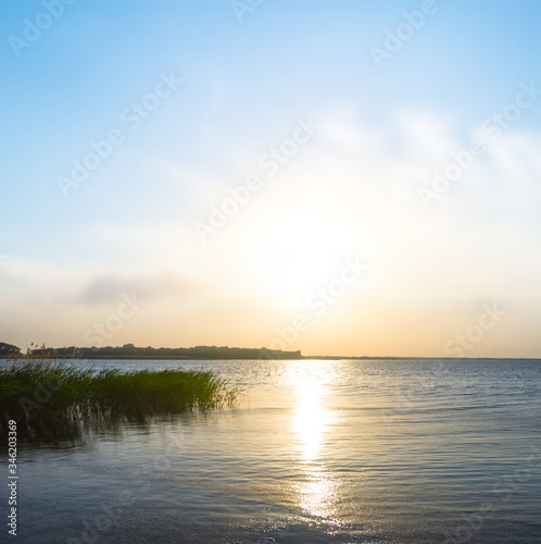 dramatic sunset over quiet lake