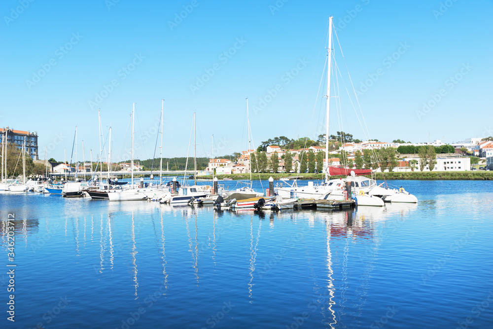 white yachts and boats stand near the pier in a small European city in the summer, a luxury vacation for wealthy people, a picturesque landscape