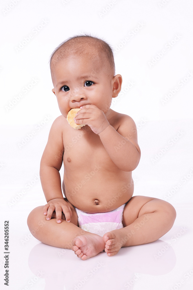 A Little Cute Asian Baby girl eating biscuit wearing diaper A Little Cute Asian Baby girl eating biscuit wearing diaper