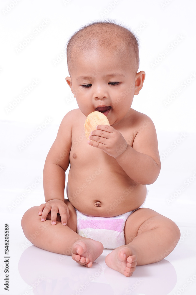 A Little Cute Asian Baby girl wearing diaper open her mouth ready eating biscuit A Little Cute Asian Baby girl wearing diaper open her mouth ready eating biscuit