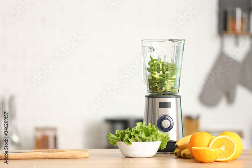 Fototapeta Naklejka Na Ścianę i Meble -  Modern blender with fresh fruits and vegetables on table in kitchen