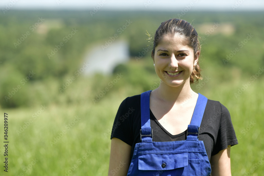 Portrait of young farmer woman with blue overalls Portrait of young farmer woman with blue overalls