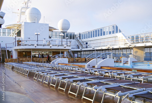 Swimmingpool with pool deck and sun deck and panoramic view of cruiseship or cruise ship liner for dream vacation photo