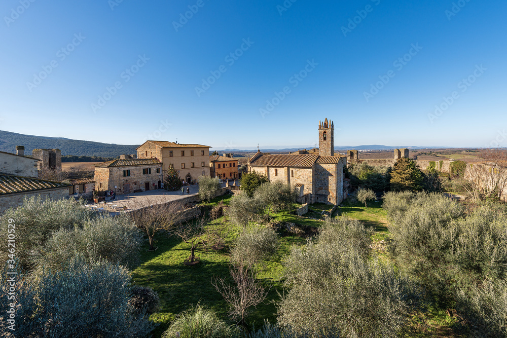 Medieval village of Monteriggioni. Church of Santa Maria Assunta (XIII century) and surrounding wall. Siena province, Tuscany, Italy, Europe
