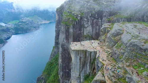 Aerial drone flight over Pulpit Rock a.k.a. Preacher’s Chair. The famous tourist place Preikestolen in the mountains of Norway. Taken in summer in foggy weather