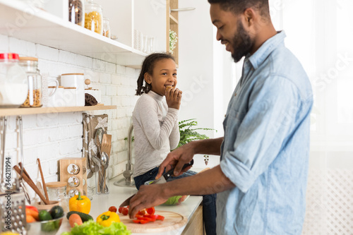 Father and daughter preparing healthy food together at home