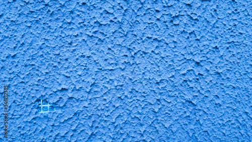 Textured plaster a blue background in style grunge.