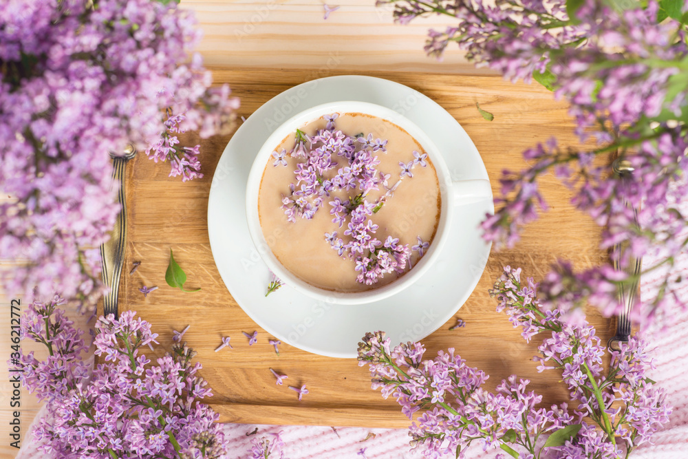 Cocoa with lilac in a cup, on the table, milk and a notebook, flat lay-out, photo for the spring blog
Cocoa with lilac in a cup, on the table, milk and a notebook, flat lay-out, photo for the spring blog