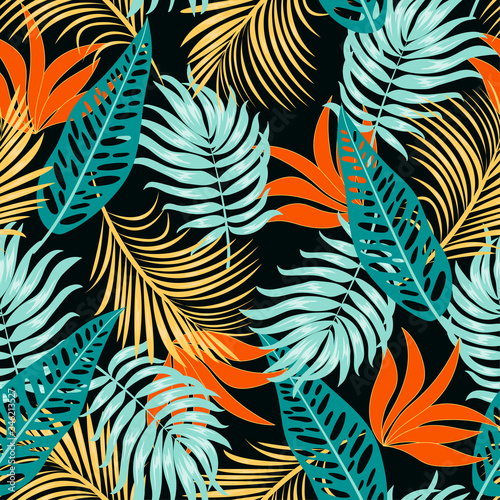 Fashionable seamless tropical pattern with bright plants and leaves on a dark background. Colorful stylish floral. Beautiful print with hand drawn exotic plants. Hawaiian style.