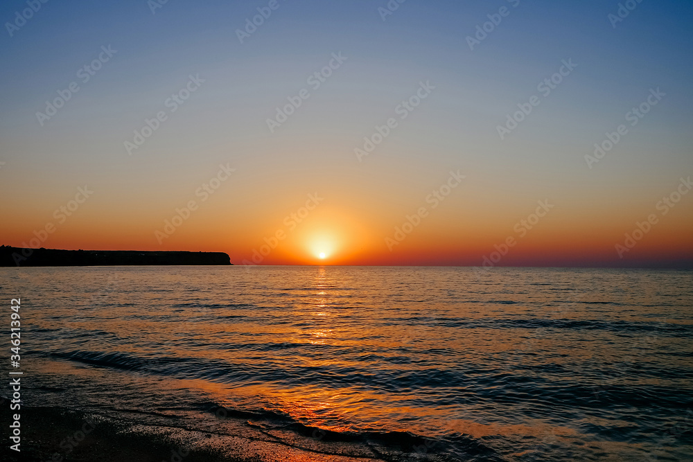A bright warm beautiful sunset on the seashore
