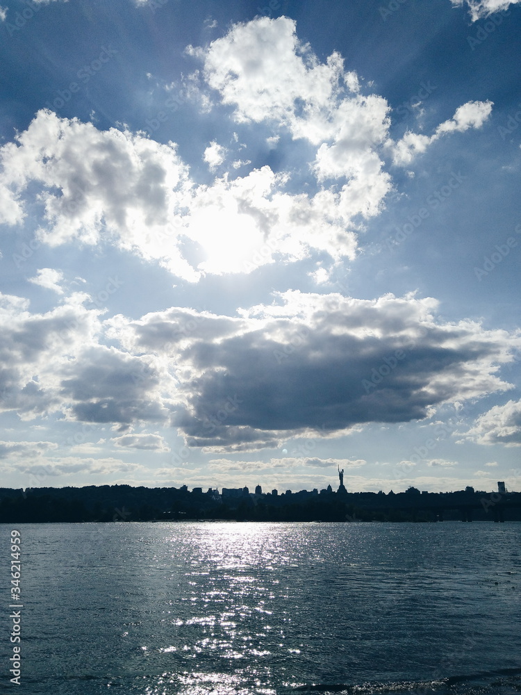 Sunny morning in clouds  in city landscape of river Dnipro