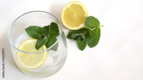 Refreshing drink with mint and lemon on the rocks
