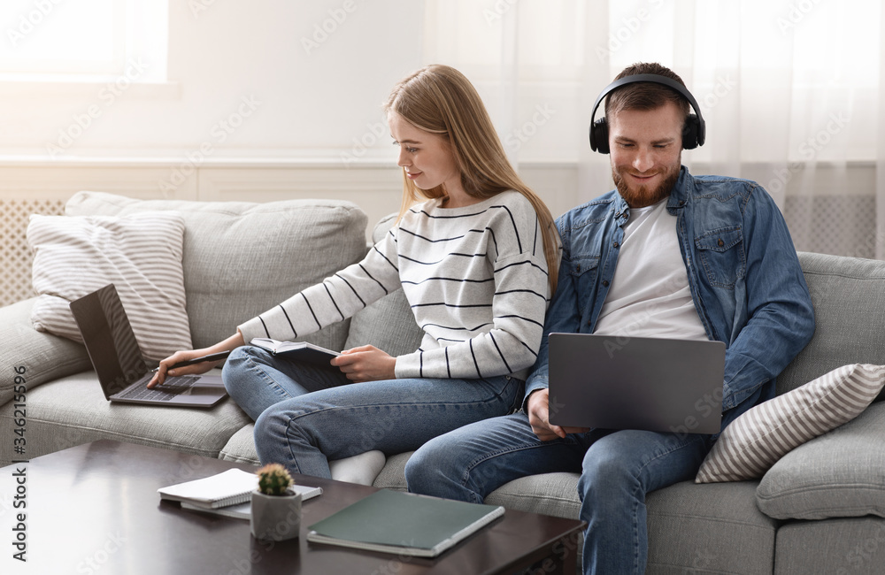 Millennial couple spending time with gadgets online