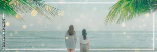 abstract blur web banner summer background from two woman stand see to beach and blue sea with coconut leaf on sunny day