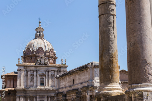 stone buildings of the city of Rome, ornate stone facade, rectangular building with round dome © Eloy