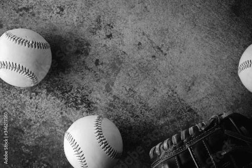 Baseball sport background with vintage texture, top view of balls with glove in black and white.