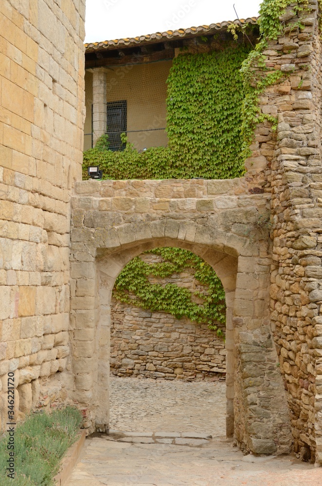 Arch at cobbled street in Girona village