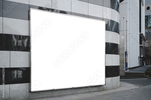 Fototapeta Naklejka Na Ścianę i Meble -  Blank white mockup of bus stop vertical billboard in front of empty street background.