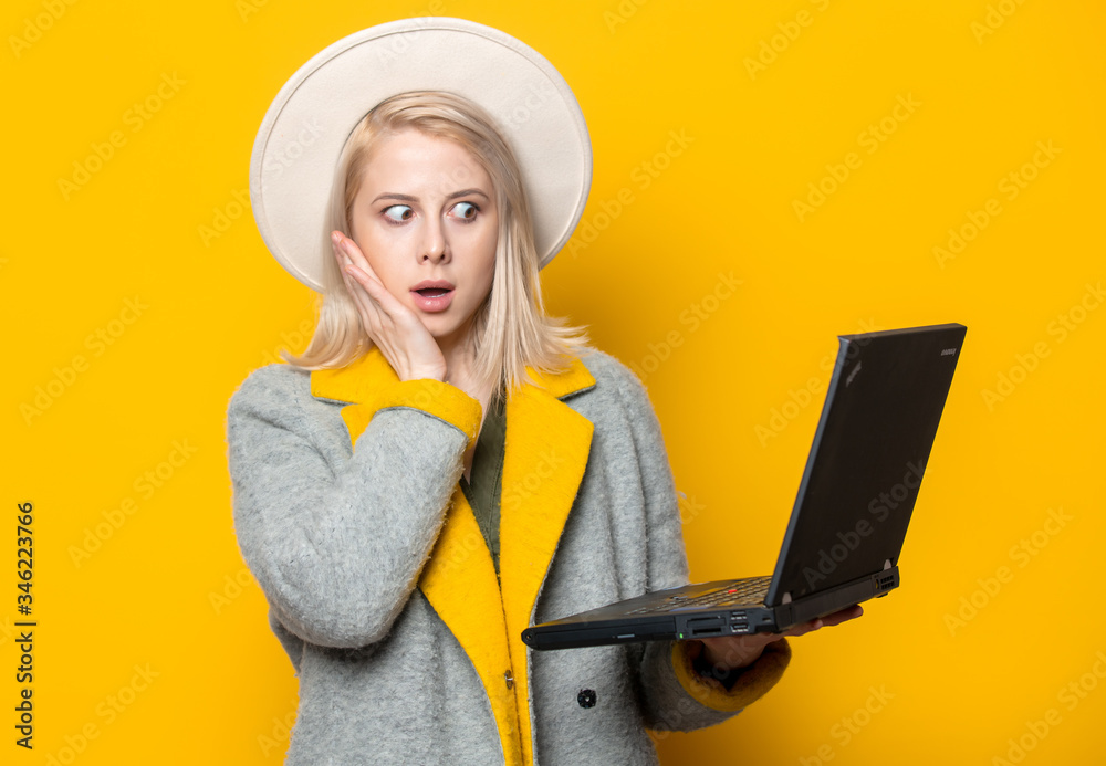 Blode woman in hat and coat with notebook Blode woman in hat and coat with notebook