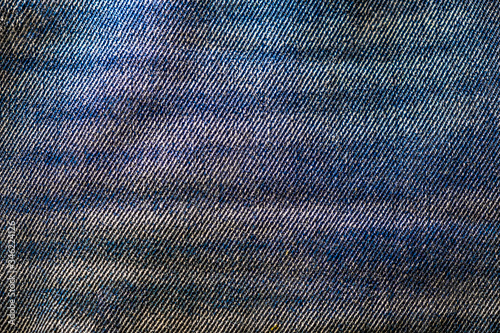Photograph of a piece of bleached denim fabric. Casual wear fiber. © mettus