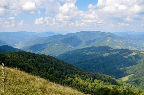 Panoramic view of picturesque Carpathian Mountains landscape with forest slopes, mountain ranges and peaks. Holidays in the mountains. © Dmytro