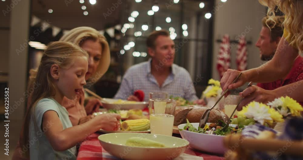 Happy family eating dinner together.