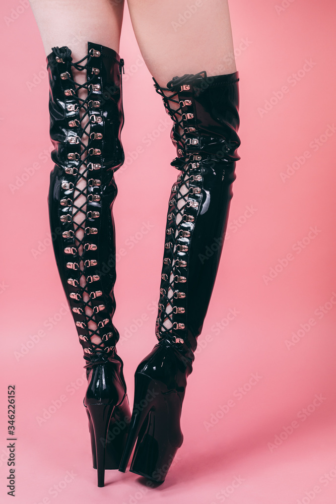 money Environmentalist To edit long black sexy bdsm high-heeled leather boots on a pink background Stock  Photo | Adobe Stock