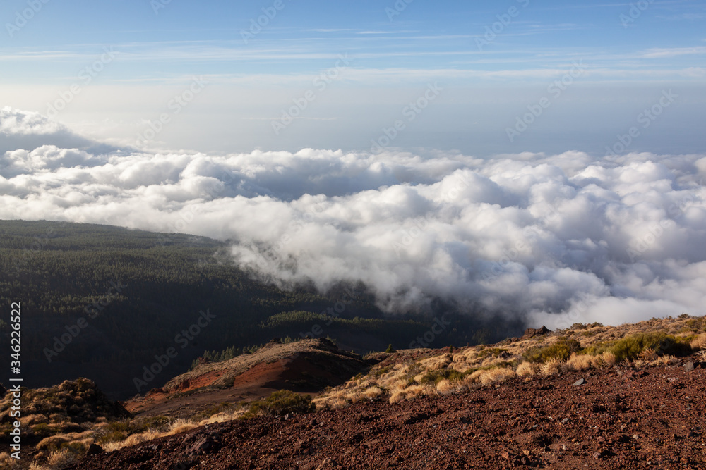 Aerial view from a volcano's slope at the clouds level in the Teide National Park, Tenerife, Canary Islands, Spain.