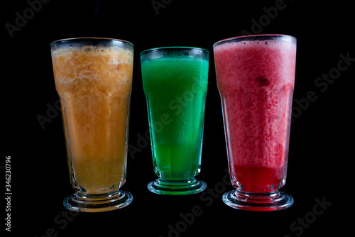 Wallpaper Mural Frozen fresh fruits drinks. Fresh fruits, juice drinks isolated on black background. iced drink. summer drink Torontodigital.ca