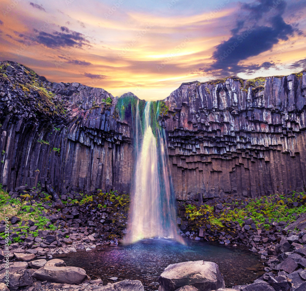 Magical landscape with a famous Svartifoss waterfall in the middle of basalt pillars in Skaftafell, Vatnajokull National Park, Iceland. Exotic countries. Amazing places. Popular tourist atraction.