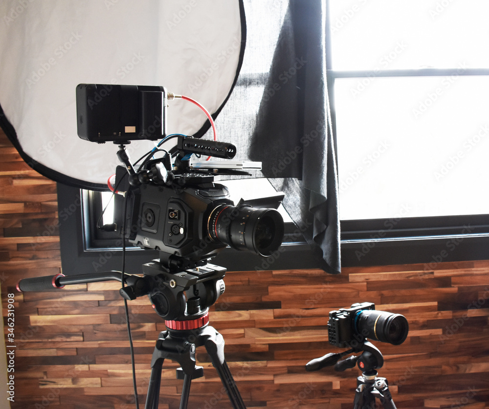 Professional camera setup with tripods & light reflector. We have a small  4k Mirrorless camera VS