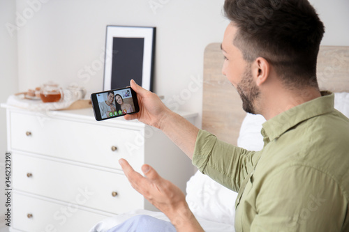 Young man video chatting wi...