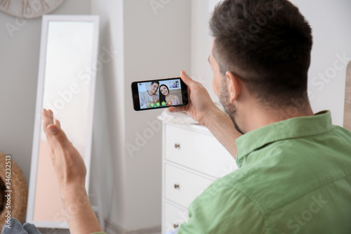Young man video chatting wi...