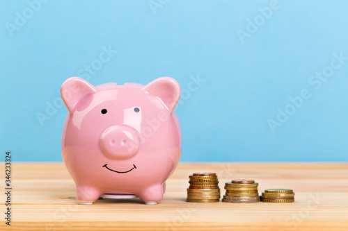 pink piggy bank on a blue background, space for text. Finance, saving money. Business to Success and Retirement Savings