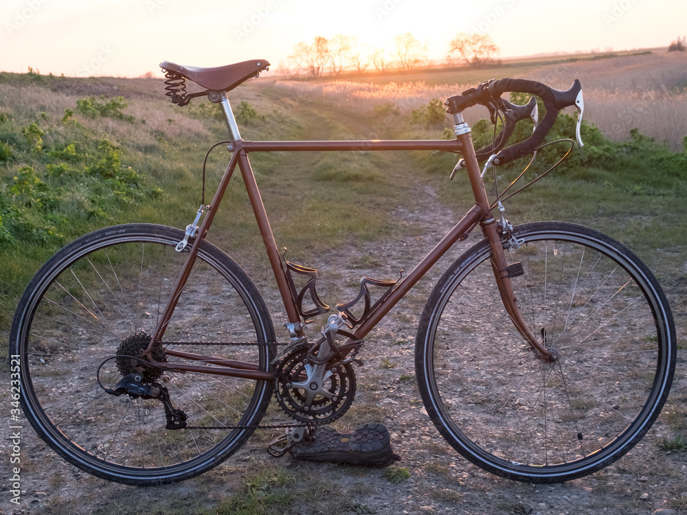 Vintage racing bike and sunset.